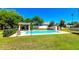Community pool surrounded by green grass and shady trees at 2941 E Nisbet Ct, Phoenix, AZ 85032