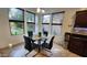 Bright breakfast nook with backyard views featuring a glass table with seating for four at 29740 N 121St Ave, Peoria, AZ 85383