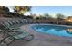 Outdoor community swimming pool with plenty of lounge chairs on the pool deck at 29740 N 121St Ave, Peoria, AZ 85383