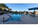 Outdoor community pool featuring poolside seating and shaded umbrellas overlooking desert landscaping at 29740 N 121St Ave, Peoria, AZ 85383