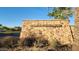 Stone entrance sign for Mountain Vista Club with desert landscaping and a view of the neighborhood at 29740 N 121St Ave, Peoria, AZ 85383