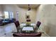 Elegant dining room with seating for four and an open view of the adjacent living area at 29740 N 121St Ave, Peoria, AZ 85383