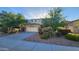 Charming home featuring mature trees and landscaping, a two-car garage, and an inviting facade at 29740 N 121St Ave, Peoria, AZ 85383