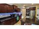 Updated kitchen with granite countertops, dark wood cabinets, and stainless steel appliances at 29740 N 121St Ave, Peoria, AZ 85383