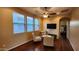 Cozy living room with natural light, chairs, television, and ceiling fan at 29740 N 121St Ave, Peoria, AZ 85383