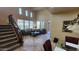 Inviting living room featuring a staircase, comfortable seating, and natural lighting at 29740 N 121St Ave, Peoria, AZ 85383