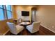Cozy living room with accent chairs and a wall-mounted television at 29740 N 121St Ave, Peoria, AZ 85383