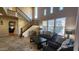 Bright living room with high ceilings, large windows, and comfortable seating arrangements at 29740 N 121St Ave, Peoria, AZ 85383