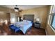 Main bedroom featuring a decorative bed frame, bench, and hardwood floors at 29740 N 121St Ave, Peoria, AZ 85383