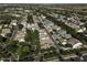 Overhead view of a residential area featuring tree-lined streets and a mix of single-Gathering homes in a green setting at 3065 E Tamarisk St, Gilbert, AZ 85296