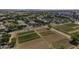 A bird's eye view showcases residential area near farmland and commercial properties at 3065 E Tamarisk St, Gilbert, AZ 85296