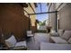 Backyard view featuring covered seating, hardscape and artificial turf at 3065 E Tamarisk St, Gilbert, AZ 85296