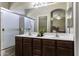 Well-lit bathroom features a double sink vanity, a large mirror, and a shower at 3065 E Tamarisk St, Gilbert, AZ 85296