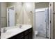 Bright bathroom featuring a double sink vanity, white cabinets, and a shower at 3065 E Tamarisk St, Gilbert, AZ 85296