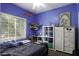 This bedroom features blue walls, a window with blinds, and playful decorations at 3065 E Tamarisk St, Gilbert, AZ 85296