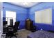 Cozy bedroom features light blue walls, two windows and wood dresser at 3065 E Tamarisk St, Gilbert, AZ 85296