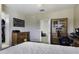 Comfortable bedroom featuring a ceiling fan, wood furniture, and a view to the hallway at 3065 E Tamarisk St, Gilbert, AZ 85296