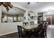 Comfortable dining room featuring hardwood floors, a rustic table, and views into an adjacent living space at 3065 E Tamarisk St, Gilbert, AZ 85296