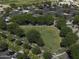 Aerial view capturing an expansive green space in the neighborhood and a parking lot with mature trees at 3065 E Tamarisk St, Gilbert, AZ 85296