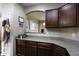Eat-in kitchen featuring granite countertops, wood cabinets, and stainless steel appliances at 3065 E Tamarisk St, Gilbert, AZ 85296