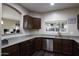 Well-lit kitchen features granite countertops, wood cabinets, and stainless steel appliances at 3065 E Tamarisk St, Gilbert, AZ 85296