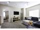 Comfortable living room with a flat-screen TV, ceiling fan, and access to a bedroom at 3065 E Tamarisk St, Gilbert, AZ 85296