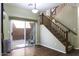Bright living room boasts wood floors, backyard access, and a staircase with wood railing at 3065 E Tamarisk St, Gilbert, AZ 85296