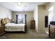 Bright main bedroom with a large window, wood furniture, and ceiling fan at 3065 E Tamarisk St, Gilbert, AZ 85296