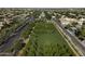 This aerial photo shows a community with a large green space with trees lining the streets between the houses at 3065 E Tamarisk St, Gilbert, AZ 85296