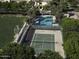 An aerial view of tennis and pickleball courts near a community pool with palm trees, perfect for recreation at 3065 E Tamarisk St, Gilbert, AZ 85296