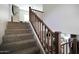Carpeted staircase with wooden banister leads to the upper level of this beautiful home at 3065 E Tamarisk St, Gilbert, AZ 85296