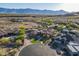 Wide aerial shot of a neighborhood featuring a home with large lot, mature landscaping, pool, and mountain backdrop at 3118 W Glenhaven Dr, Phoenix, AZ 85045
