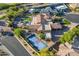 High angle view of a sprawling property with pool, tennis court, and lush landscaping in a quiet neighborhood at 3118 W Glenhaven Dr, Phoenix, AZ 85045
