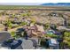 Panoramic aerial view of property with lush landscaping, tennis court, pool, and serene desert surroundings at 3118 W Glenhaven Dr, Phoenix, AZ 85045