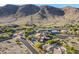 Stunning aerial view of an upscale desert community nestled against majestic mountains and clear blue skies at 3118 W Glenhaven Dr, Phoenix, AZ 85045