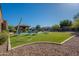 Beautiful backyard with pool, spa, outdoor kitchen, and desert landscaping is ideal for entertaining at 3118 W Glenhaven Dr, Phoenix, AZ 85045
