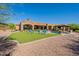Manicured backyard showcasing a stunning pool, covered outdoor kitchen, and meticulously maintained landscaping at 3118 W Glenhaven Dr, Phoenix, AZ 85045