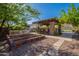 Backyard featuring an outdoor kitchen, raised garden beds, seating area, and privacy landscaping at 3118 W Glenhaven Dr, Phoenix, AZ 85045