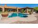 The backyard pool features a tiled pool and spa, plus beautiful stone and plants all around at 3118 W Glenhaven Dr, Phoenix, AZ 85045