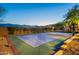 Multi-use basketball and tennis court with mountain views surrounded by desert landscape at 3118 W Glenhaven Dr, Phoenix, AZ 85045