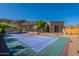 Wide backyard angle featuring a full basketball court, privacy landscaping, and home exterior at 3118 W Glenhaven Dr, Phoenix, AZ 85045