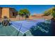 Private backyard featuring a full basketball court, lush trees, and privacy landscaping at 3118 W Glenhaven Dr, Phoenix, AZ 85045