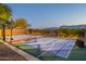 Multi-use basketball and tennis court with mountain views surrounded by desert landscape at 3118 W Glenhaven Dr, Phoenix, AZ 85045
