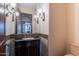 Elegant bathroom with a vessel sink vanity and stylish lighting at 3118 W Glenhaven Dr, Phoenix, AZ 85045