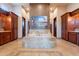 Bright bathroom featuring a central soaking tub with marble detail, wood cabinetry and tile flooring at 3118 W Glenhaven Dr, Phoenix, AZ 85045