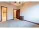 Bedroom with wood trim and multiple doors, leading to other rooms of the house at 3118 W Glenhaven Dr, Phoenix, AZ 85045