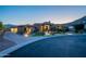 Stunning single-Gathering home with a circular driveway, beautiful architecture, and elegant curb appeal at twilight at 3118 W Glenhaven Dr, Phoenix, AZ 85045