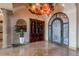 Spacious foyer with marble floors, custom lighting, and a built-in bookcase for a grand and welcoming entrance at 3118 W Glenhaven Dr, Phoenix, AZ 85045