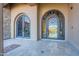Elegant double iron doors create a grand entrance to this luxurious residence, showcasing stone flooring at 3118 W Glenhaven Dr, Phoenix, AZ 85045