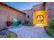 Private entry courtyard with iron and stone entry, custom sconces and peaceful desert scenery at 3118 W Glenhaven Dr, Phoenix, AZ 85045